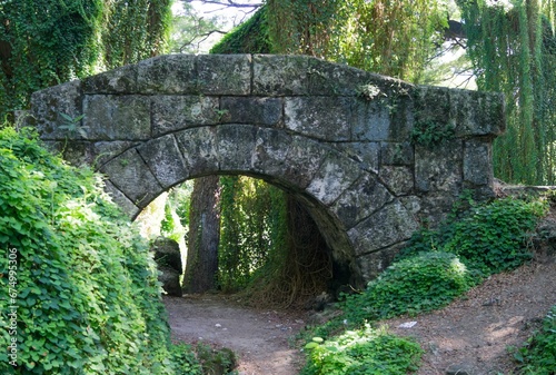 Stone bridge over the dirt road in the park