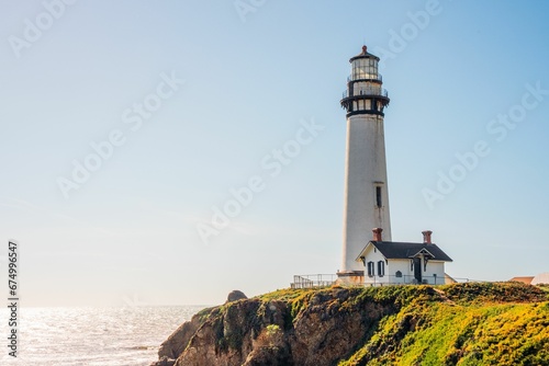 Closeup of a lighthouse on a cliff, a sunny day in coastal California