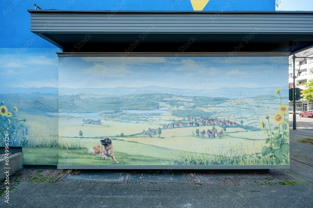 Obraz premium part of an artistically painted blue house with painted landscape with a Leonberger Dog, mural painting, in Wuppertal Oberbarmen, Berlinerstrasse