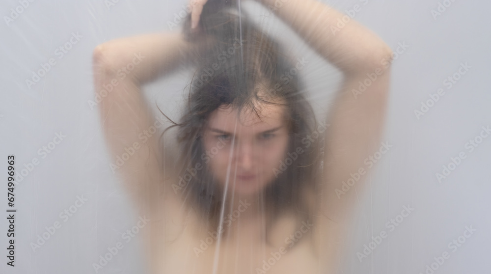 Fototapeta premium fantastic outstanding portrait in anxiety dream of beautiful sexy sensual seductive brunette woman behind a veil of transparent plastic foil as background, copy space