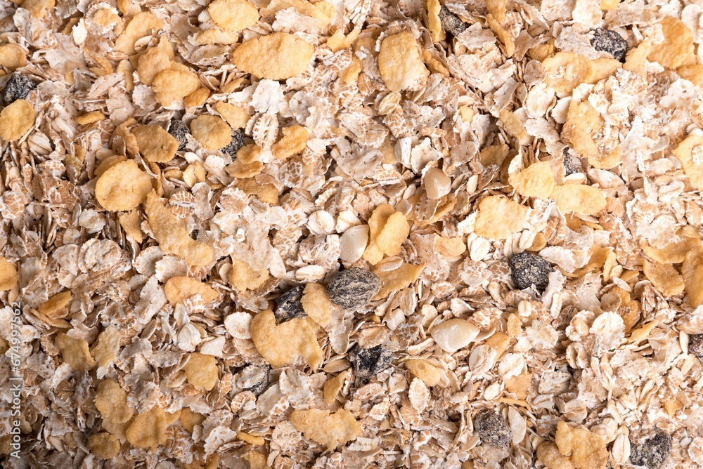 Aerial shot of a breakfast cereal with dry oatmeal, raisins, and nuts Aerial shot of a breakfast cereal with dry oatmeal, raisins, and nuts