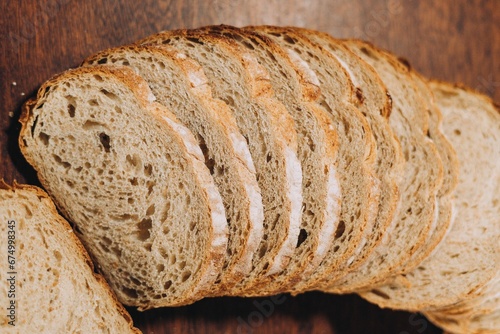 Close-up shot of a freshly sliced loaf of bread on a cutting board photo