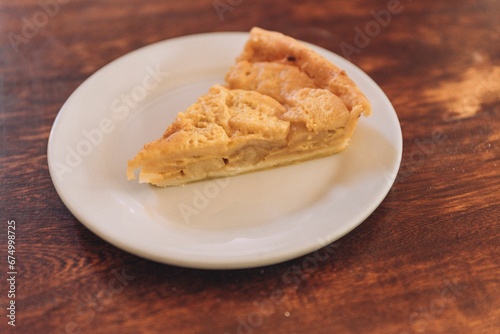 Delicious  freshly-baked cake sits atop a wooden table