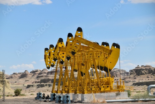 Large yellow oil rigs industrial setting, sky in the background photo