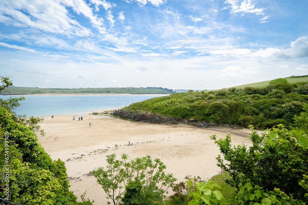 Scenic beach with many people enjoying a sunny day