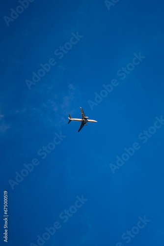 Low angle shot of an airplane flying through a sky