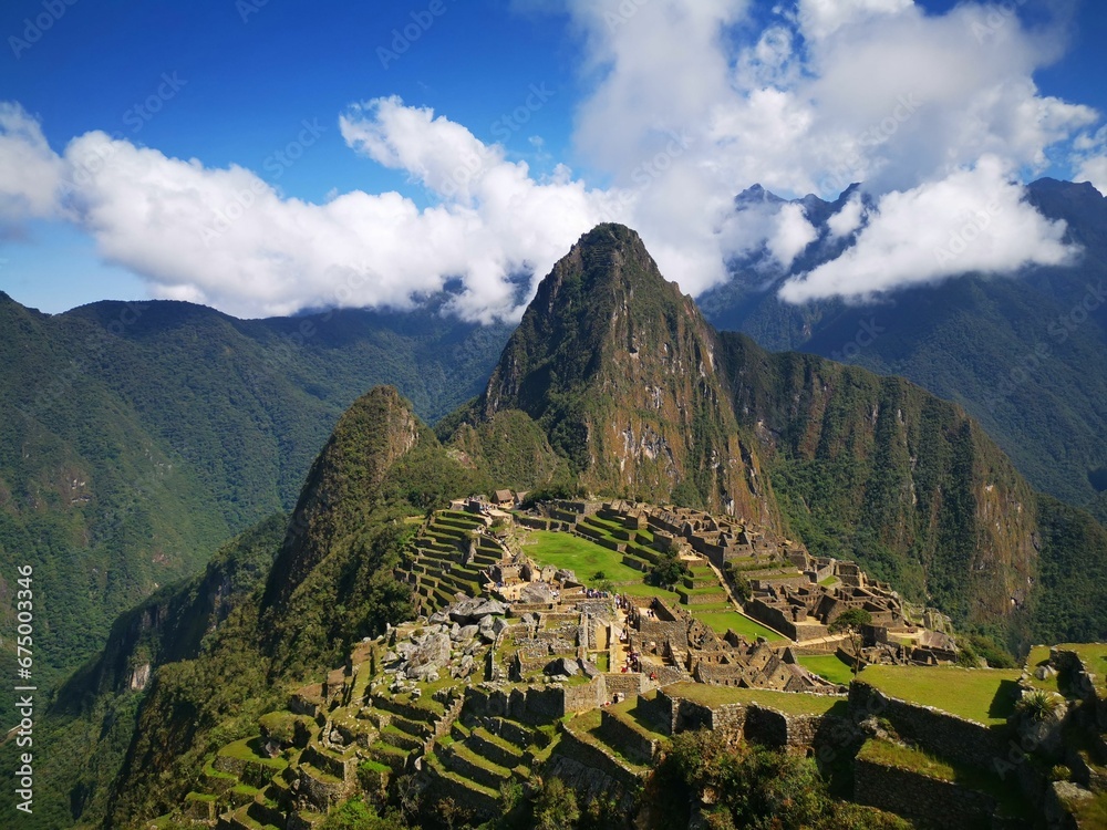 Ancient Incan site of Machu Picchu in Peru, surrounded by lush, mountainous terrain