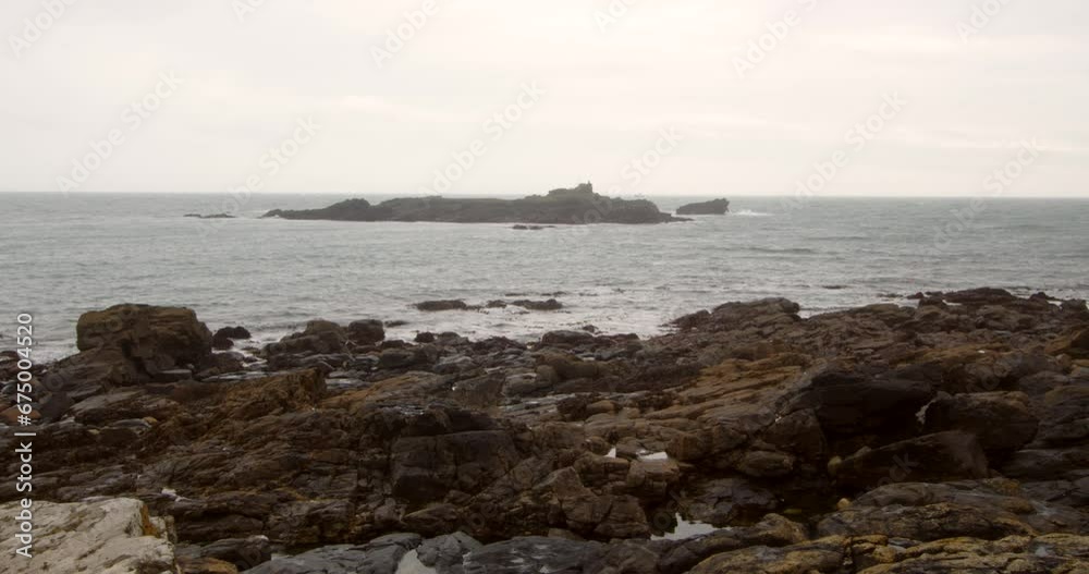 Low-level shot of St Clement's Isle with rock in foreground, Cornwall Low-level shot of St Clement's Isle with rock in foreground, Cornwall