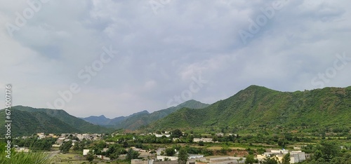 view of an outside town from the balcony of an apartment in an area with mountains