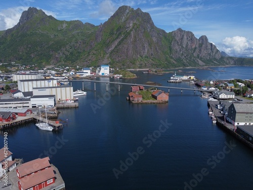 Aerial view of a cityscape of buildings and waterways in Norway, surrounded by natural landscape