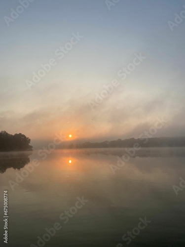Fototapeta Naklejka Na Ścianę i Meble -  sunrise in the middle of the morning with the sun reflecting on water