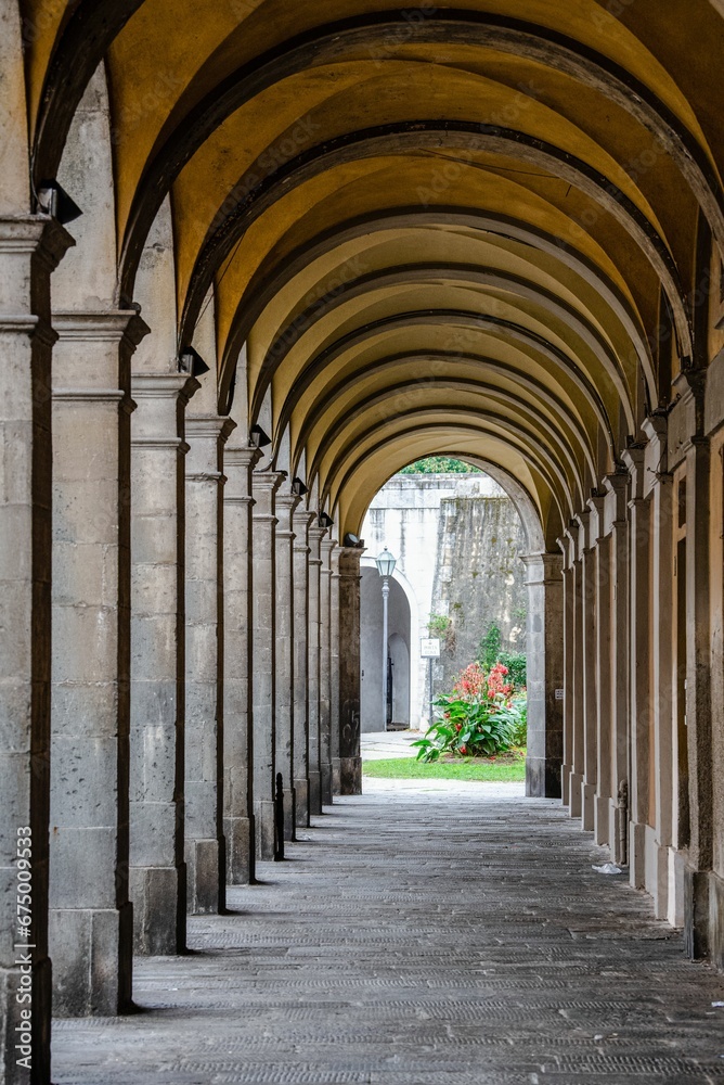 Majestic corridor featuring numerous grand arches and pillars crafted from stone