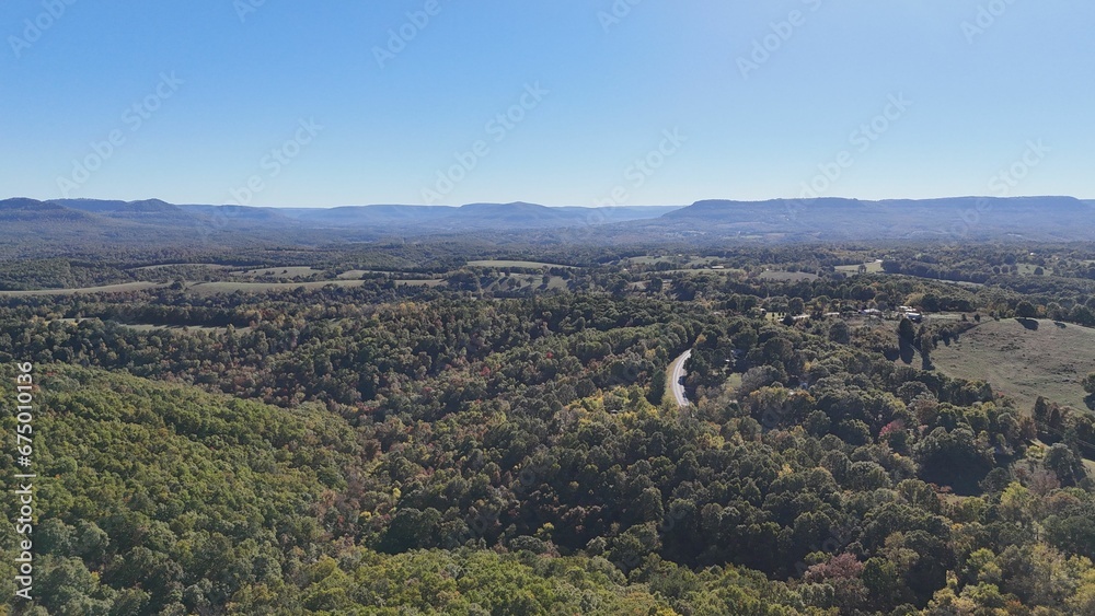 Obraz premium Aerial view of a green landscape on a sunny day