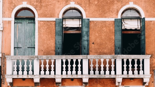 Fototapeta Naklejka Na Ścianę i Meble -  Closeup of a balcony of an old orange building in Venice, Italy
