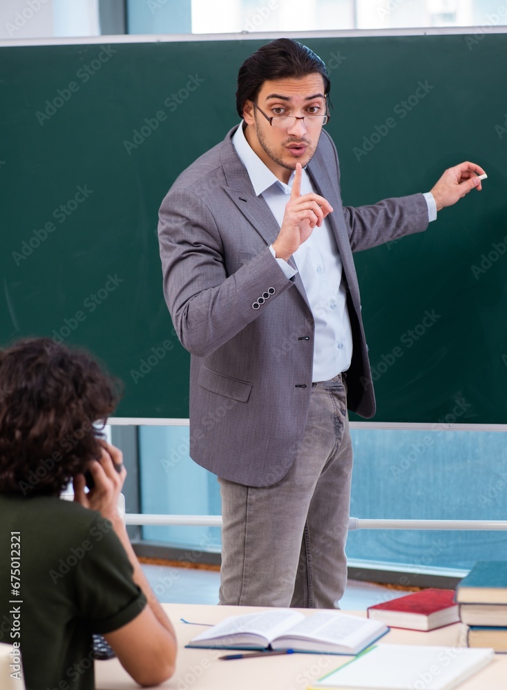 Young teacher and student in the classroom Young teacher and student in the classroom
