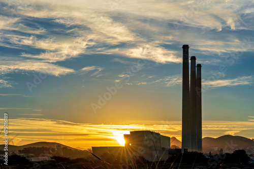 power plant with sunburst, at sunrise, sunset