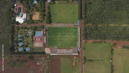 Aerial: soccer field, surrounded by greenery and buildings, in Misiones, Argentina photo