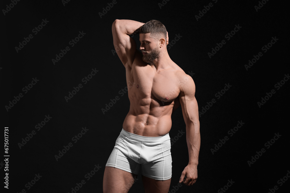 Young man in stylish white underwear on black background Young man in stylish white underwear on black background