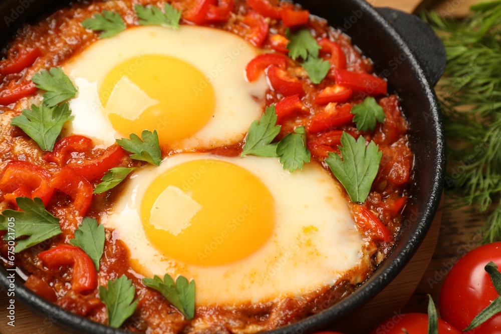 Delicious Shakshuka in pan on table, closeup Delicious Shakshuka in pan on table, closeup