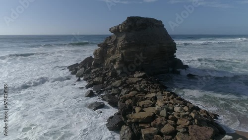 Large rock in the blue sea on a sunny day. Aerial view Rocky cliff in the ocean in  Portugal photo