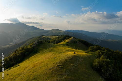 Aerial view of green hills on a sunny day © Wirestock