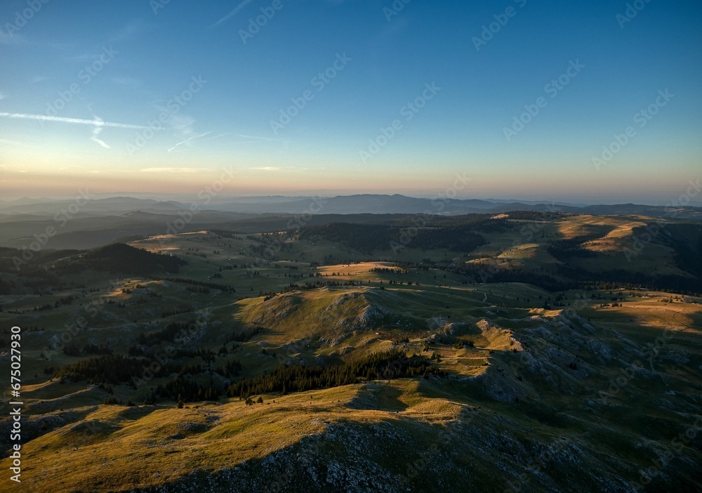 Aerial view of green hills at sunset
