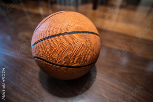 Classic basketball ball on wooden floor