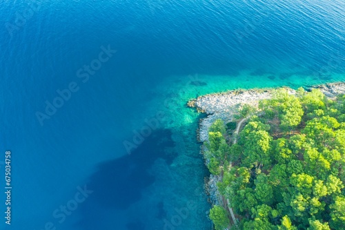 Aerial view of a scenic landscape of island in Croatia with lush greeen trees on the shore