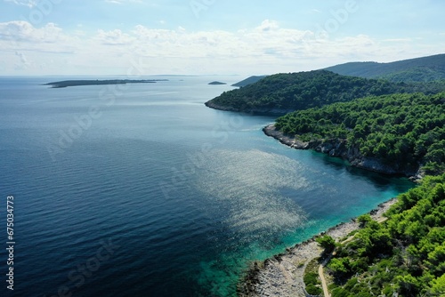 Aerial view of a scenic landscape of island in Croatia with lush greeen trees on the shore