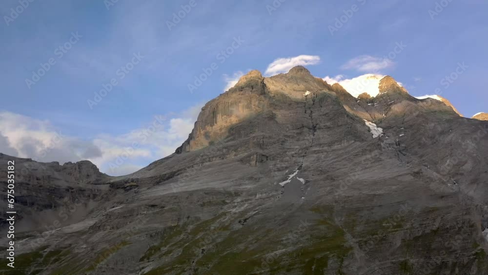 Aerial of a big rocky mountain against the blue sunny sky Aerial of a big rocky mountain against the blue sunny sky