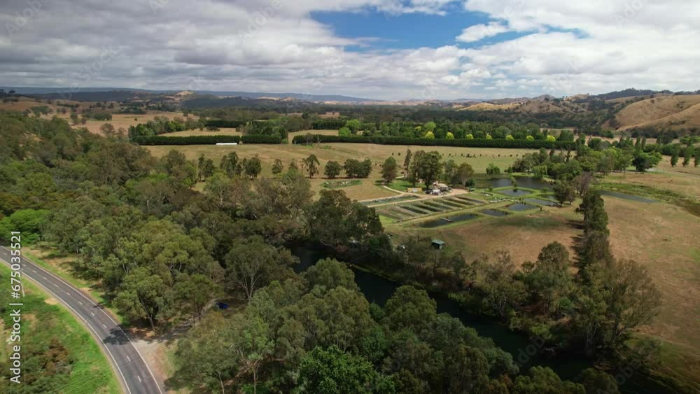 Over the Goulburn River towards farmland with ponds and hedges near Eildon, Victoria, Australia Over the Goulburn River towards farmland with ponds and hedges near Eildon, Victoria, Australia