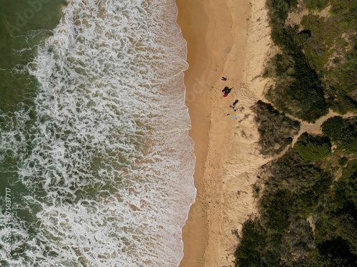 Aerial view of the scenic Tabourie Beach with forest trees nearby in Australia