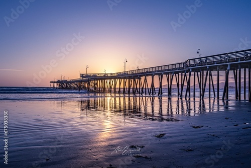 The pier at sunset, Beautiful beach © Wirestock