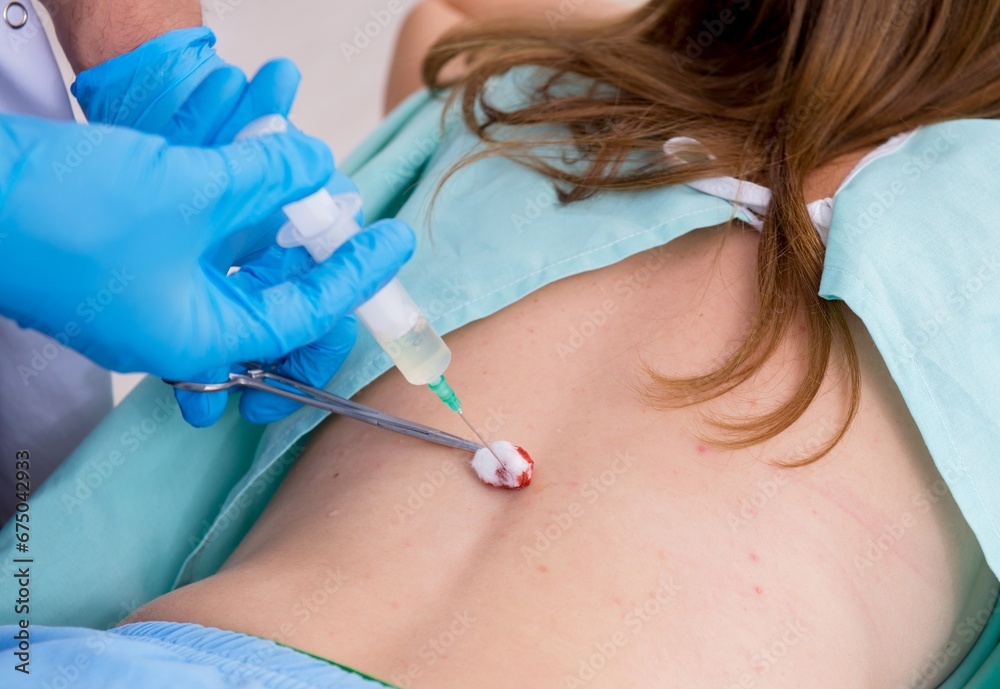 Young back injured woman visiting male doctor chiropractor Young back injured woman visiting male doctor chiropractor