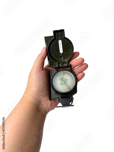 Person's hand holding a compass on white background.
