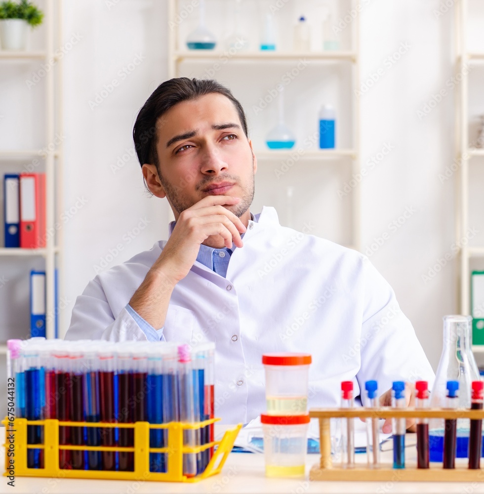 Young male chemist working in the lab Young male chemist working in the lab