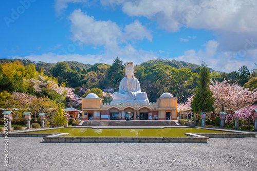 Kyoto, Japan - March 30 2023: Ryozen Kannon Temple is a war memorial dedicated to the fallen both sides of the Pacific War.The 24-meter statue of the Goddess of Mercy was built in 1955 photo