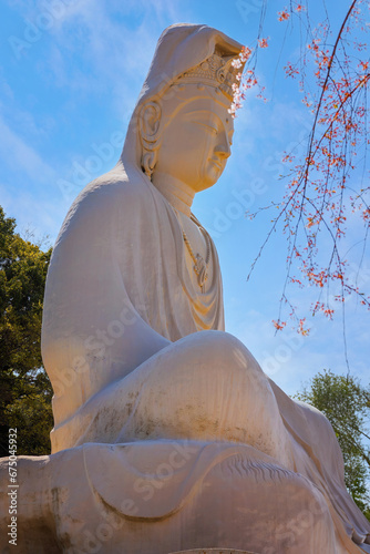 Kyoto, Japan - March 30 2023: Ryozen Kannon Temple is a war memorial dedicated to the fallen both sides of the Pacific War.The 24-meter statue of the Goddess of Mercy was built in 1955 photo
