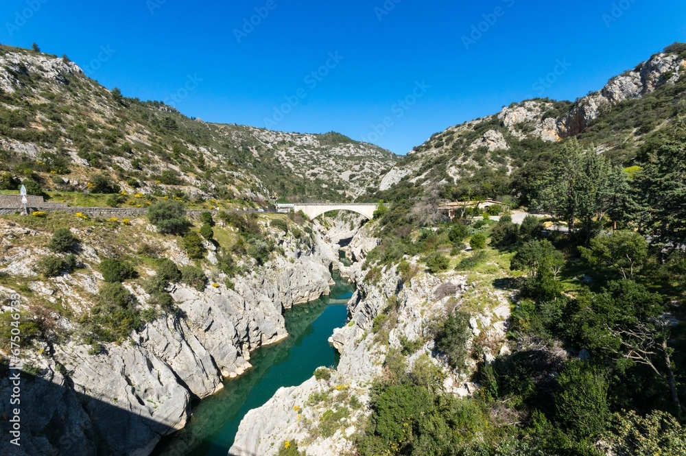Fototapeta premium Aerial view of the Devil's Bridge over a narrow gorge of the Herault river in South France