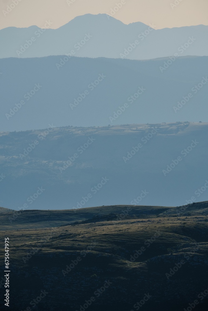 Vertical shot of a landscape with scenic mountains in the background Vertical shot of a landscape with scenic mountains in the background