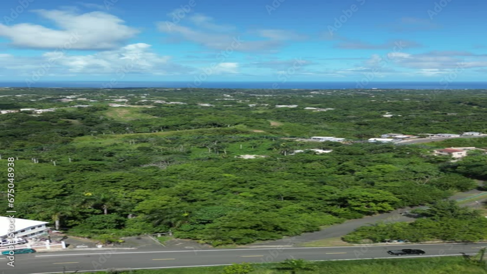 Aerial view from drone flying over the lush green rolling hills near the popular beach town of Rincon on the west coast of the island of Puerto Rico Aerial view from drone flying over the lush green rolling hills near the popular beach town of Rincon on the west coast of the island of Puerto Rico