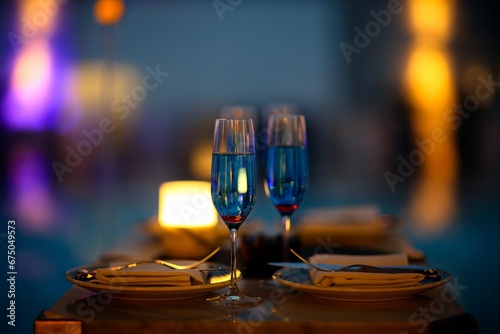 Closeup shot of champagne flutes with a blue beverage.