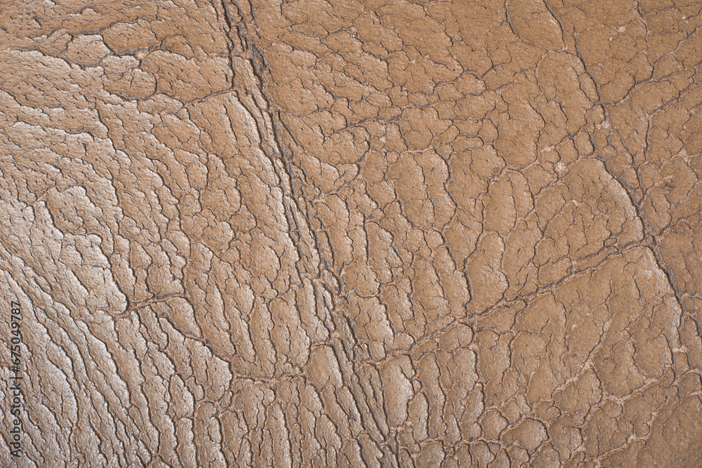 close-up aging old used leather surface, beige synthetic material seat with wear and tear, including scuffs, creases and scratches, abstract background on upholstery restoration concept in full frame