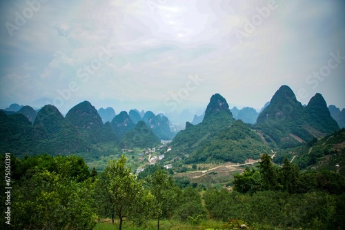 Scenic view of lush greenery and majestic mountains in the background. Guilin, China.