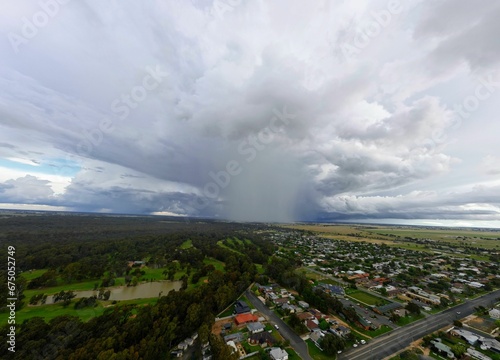 clouds are gathering over a suburban area in the middle of an aerial photo