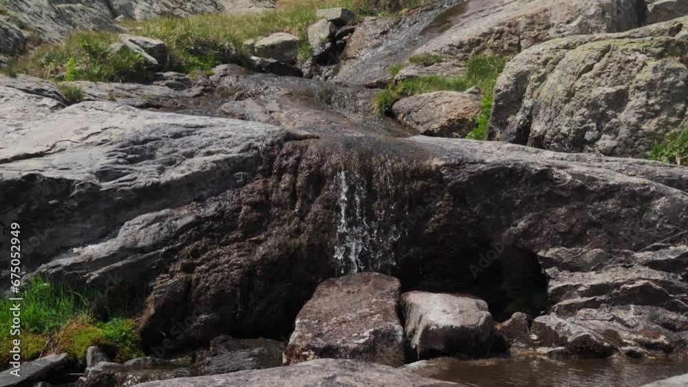 Landscape of waterfall streaming on rocky mountain Landscape of waterfall streaming on rocky mountain