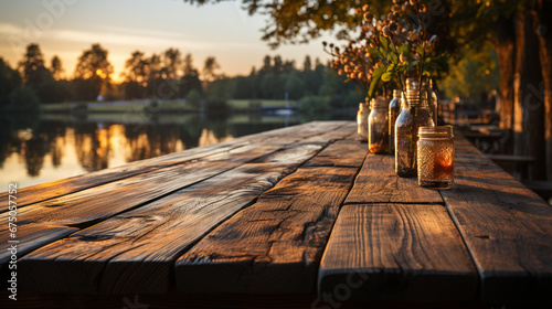A wooden table top in front with a blurred background of summer lakes and green forests.