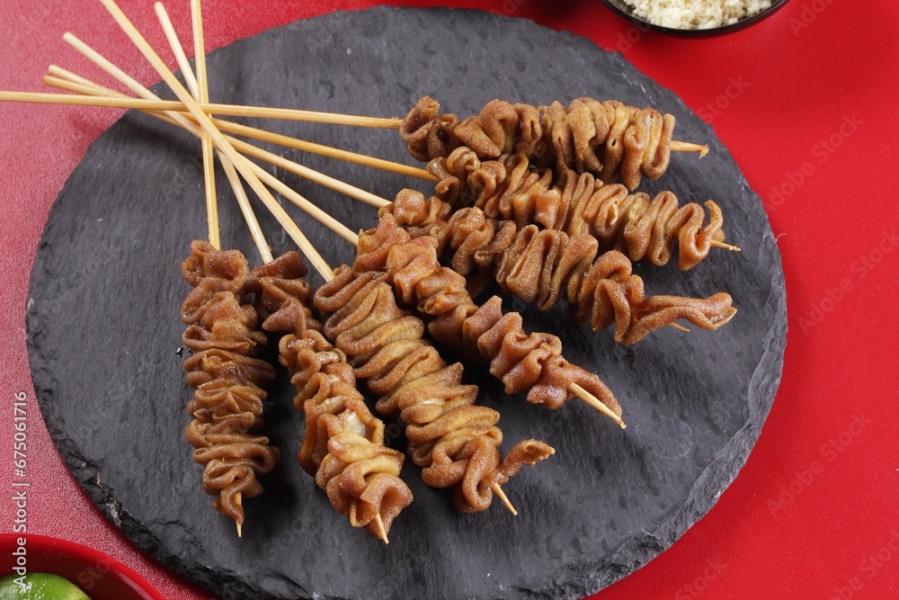 Fototapeta premium Sate taichan is a variation of chicken satay grilled and served without peanut or ketjap seasoning unlike other satays. It is served with sambal and squeezed key lime,