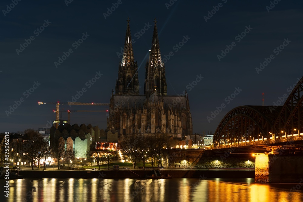 Cologne Cathedral at night with the city in the background in Cologne, Germany