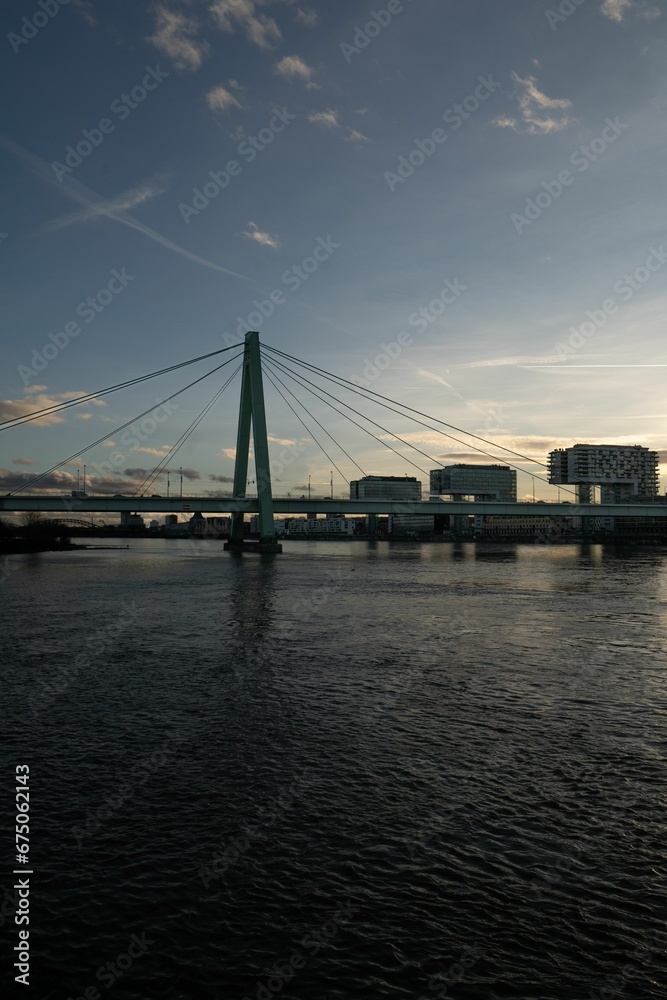 Severin Bridge in Germany, illuminated in the evening against the backdrop of a vibrant cityscape Severin Bridge in Germany, illuminated in the evening against the backdrop of a vibrant cityscape